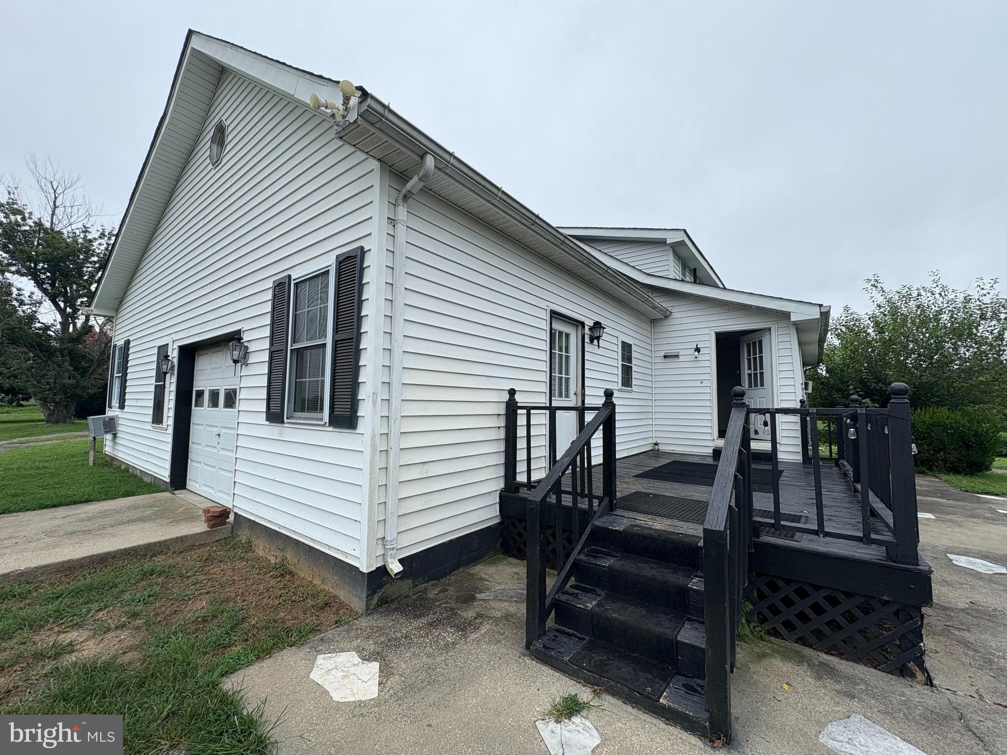 6525 Nomini Hall Road Hague, VA 22469 - Photo 3 of 44 a view of a white house with a small yard and a large tree front of house