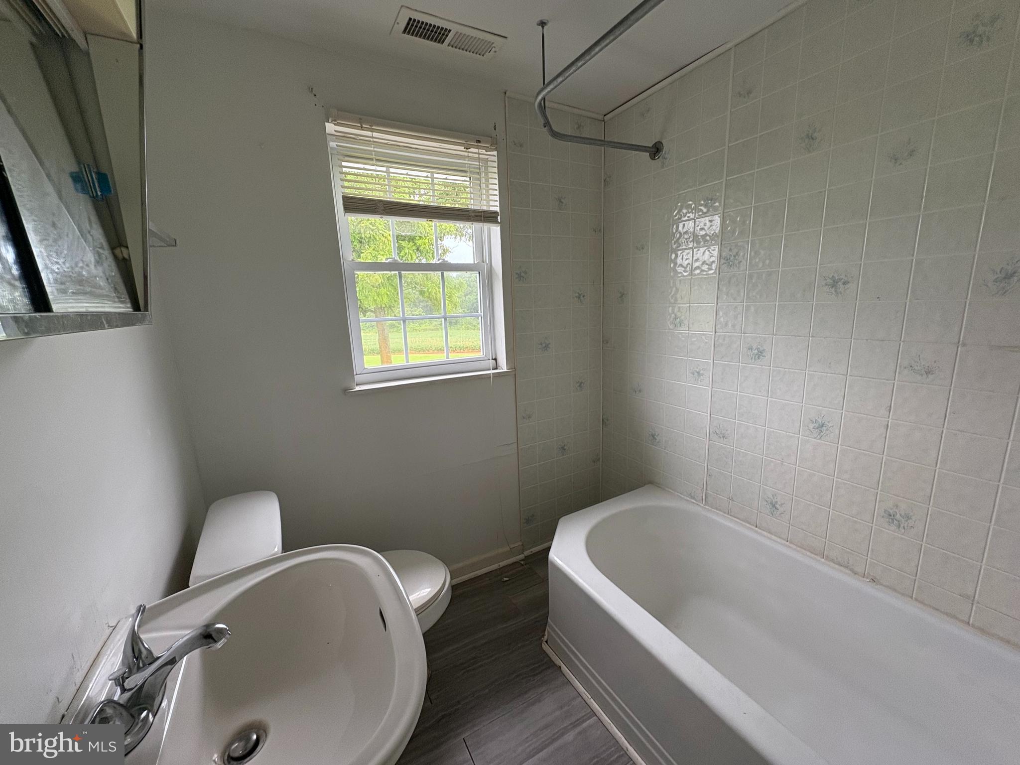 6525 Nomini Hall Road Hague, VA 22469 - Photo 31 of 44 a bathroom with a tub a sink and a toilet