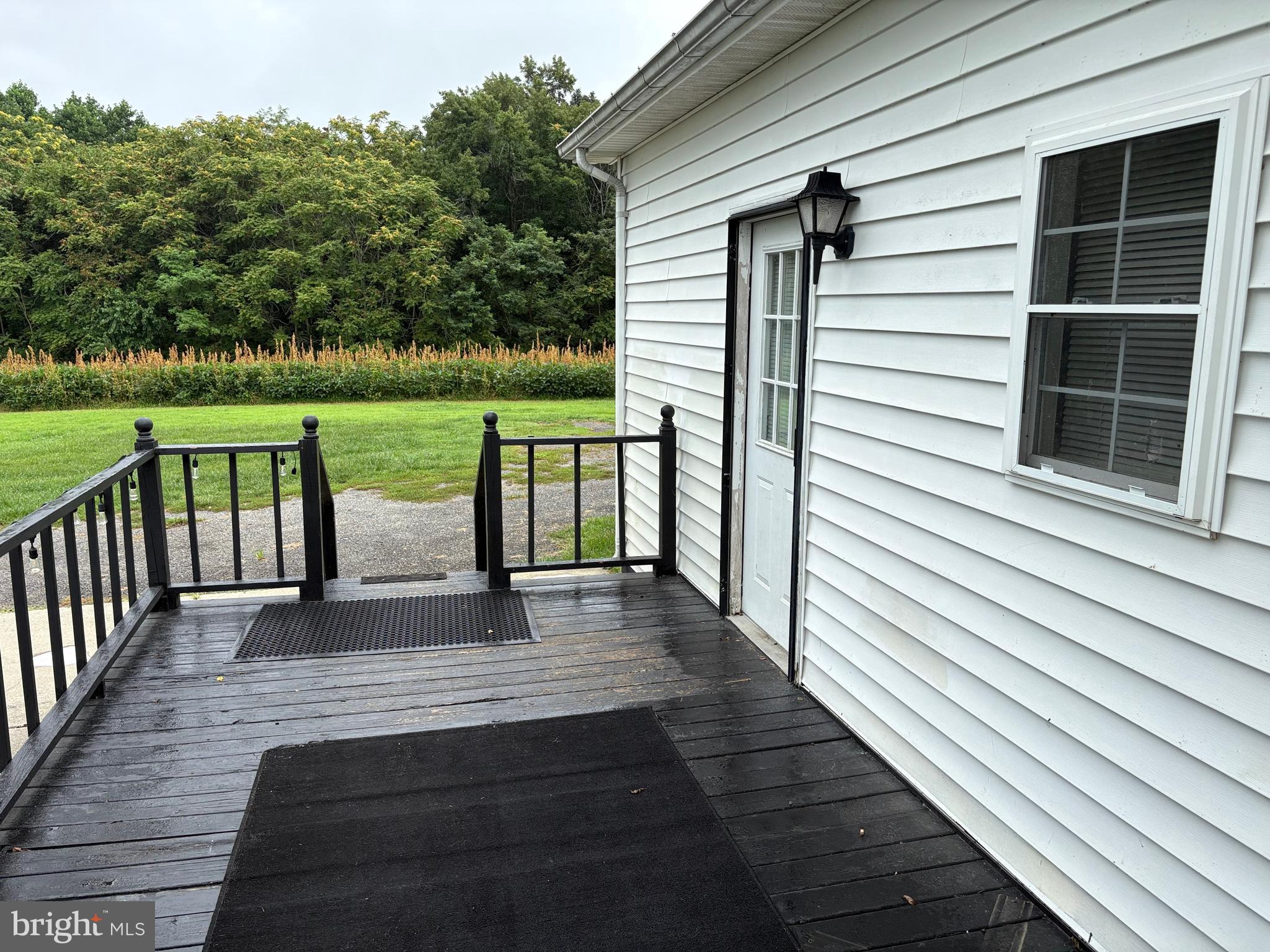 6525 Nomini Hall Road Hague, VA 22469 - Photo 34 of 44 a view of deck with two chairs and wooden floor next to a yard
