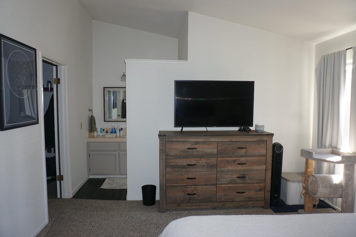 954 Wake Forest Court Merced, CA 95348 - Photo 17 of 36 a room with furniture and flat screen tv