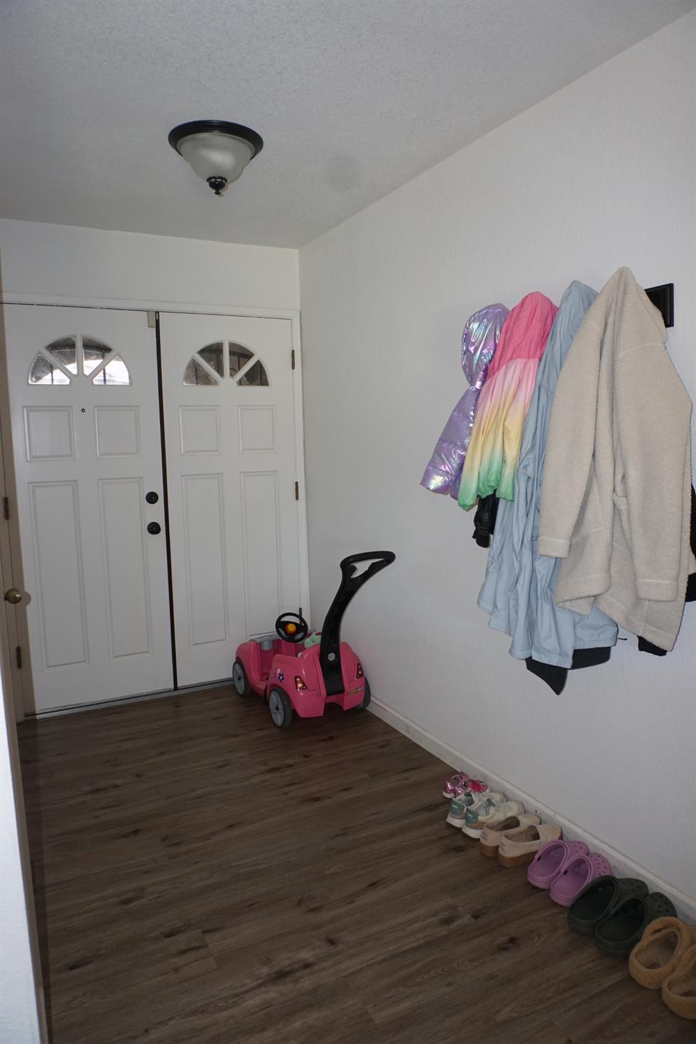 954 Wake Forest Court Merced, CA 95348 - Photo 3 of 36 a view of a room with wooden floor and closet
