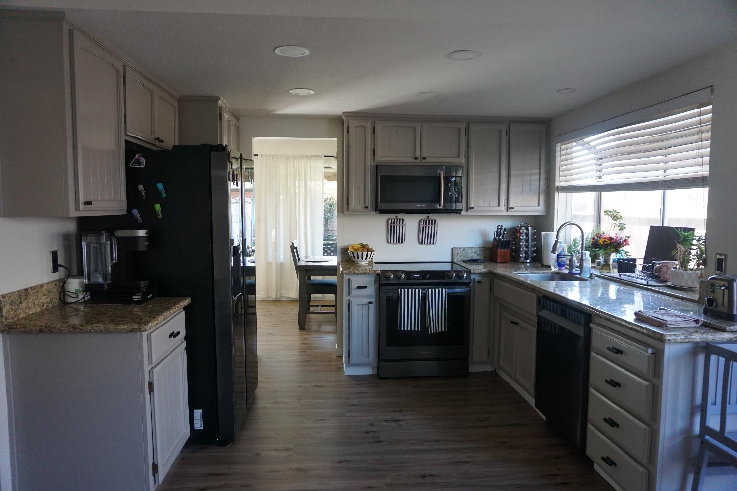 954 Wake Forest Court Merced, CA 95348 - Photo 7 of 36 a kitchen with stainless steel appliances granite countertop a refrigerator stove microwave and sink