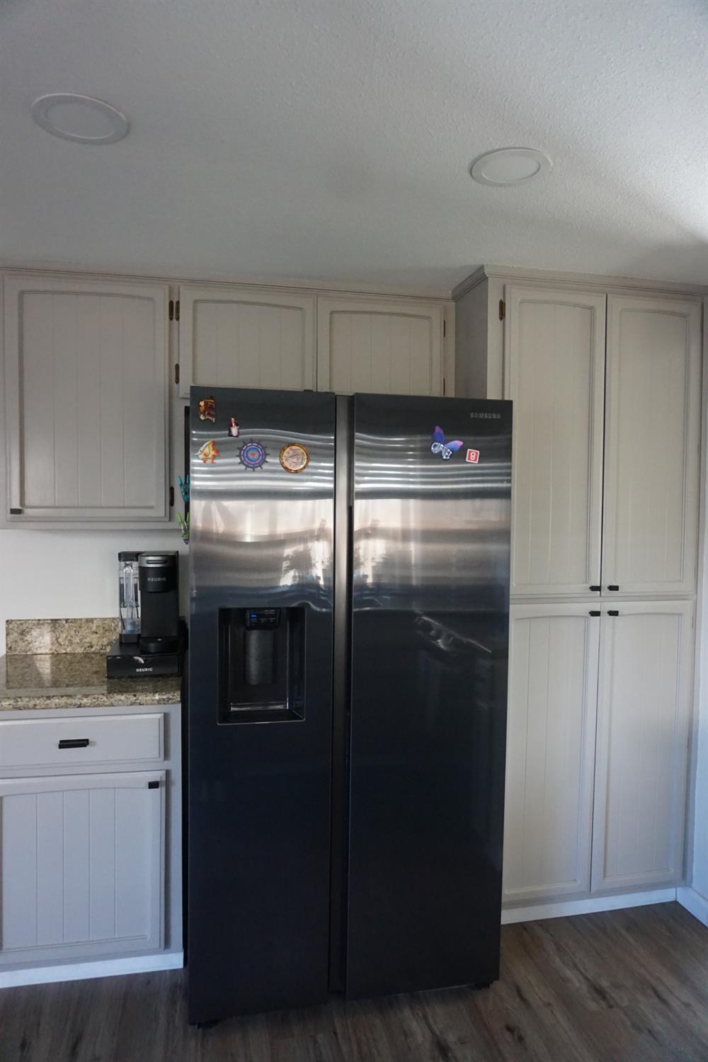 954 Wake Forest Court Merced, CA 95348 - Photo 9 of 36 a kitchen with stainless steel appliances granite countertop a refrigerator and a stove top oven