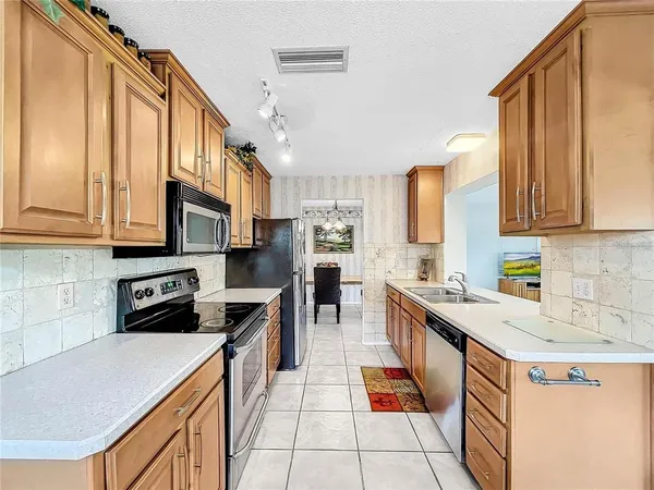 a kitchen with stainless steel appliances a stove a microwave and cabinets