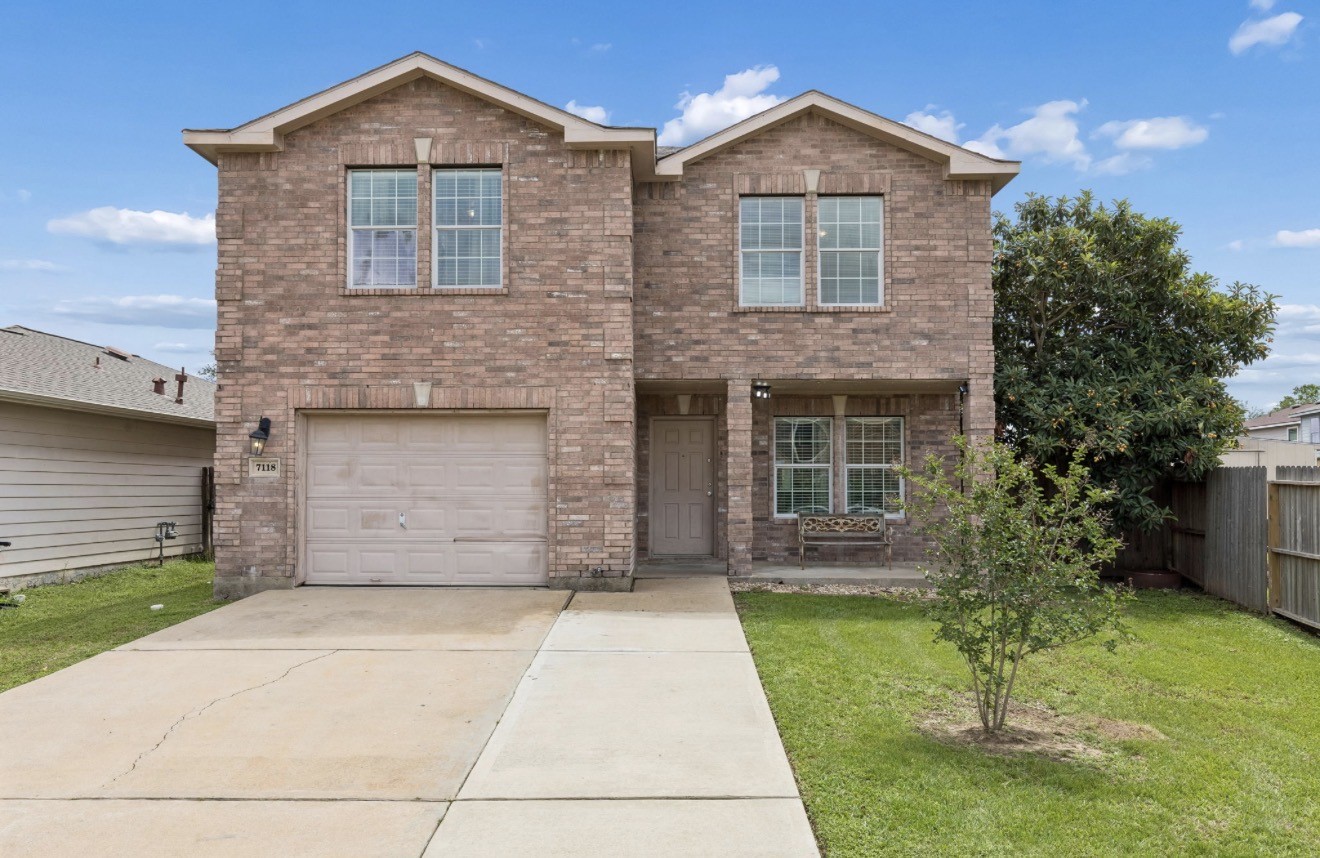 7118 Rising Brook Drive Cypress, TX 77433 - Photo 1 of 21 a front view of a house with a yard and garage
