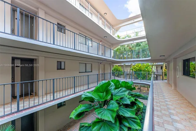 a view of a house with a small yard and wooden floor