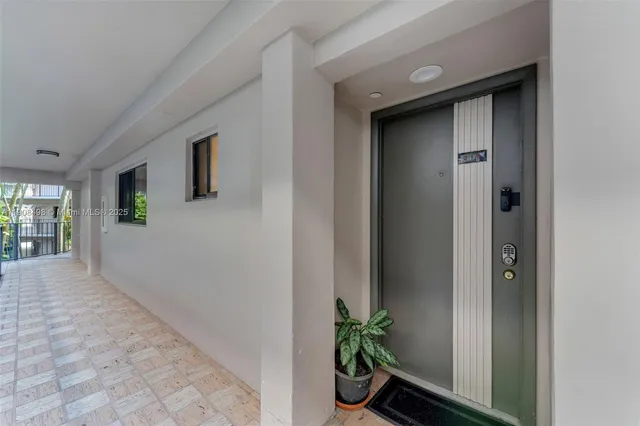 a hallway with front door and wooden floor