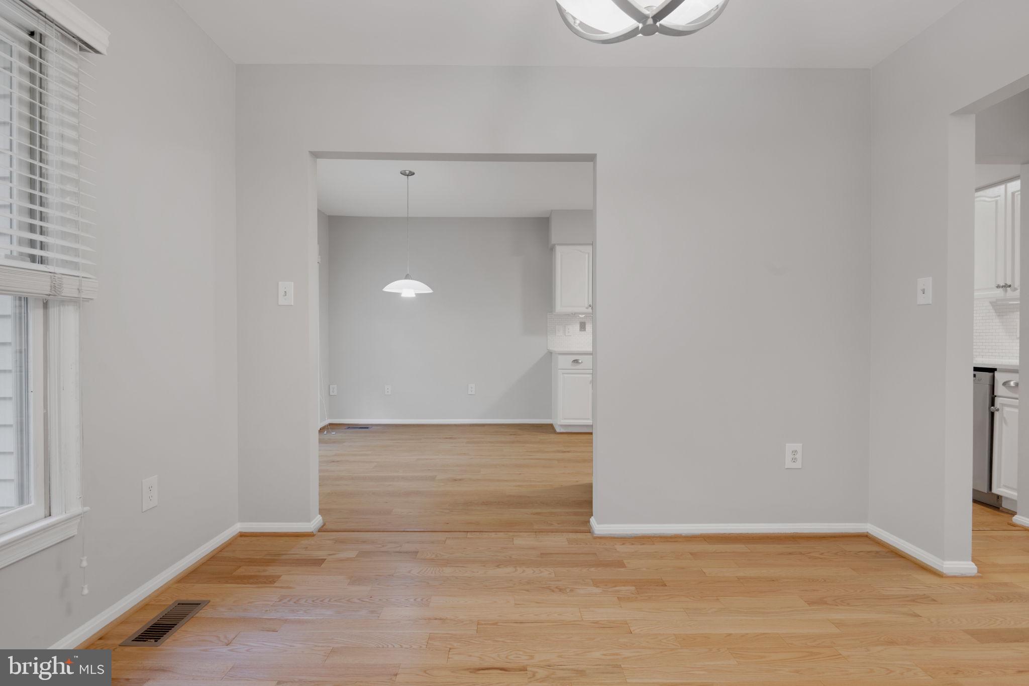 7267 Olde Lantern Way Springfield, VA 22152 - Photo 8 of 52 a view of an empty room with wooden floor and a window