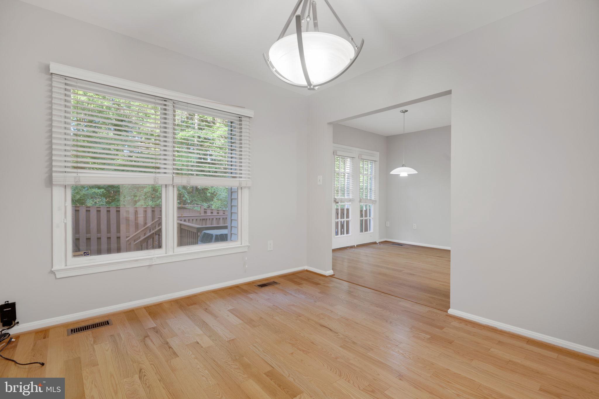 7267 Olde Lantern Way Springfield, VA 22152 - Photo 9 of 52 a view of an empty room with wooden floor and a window