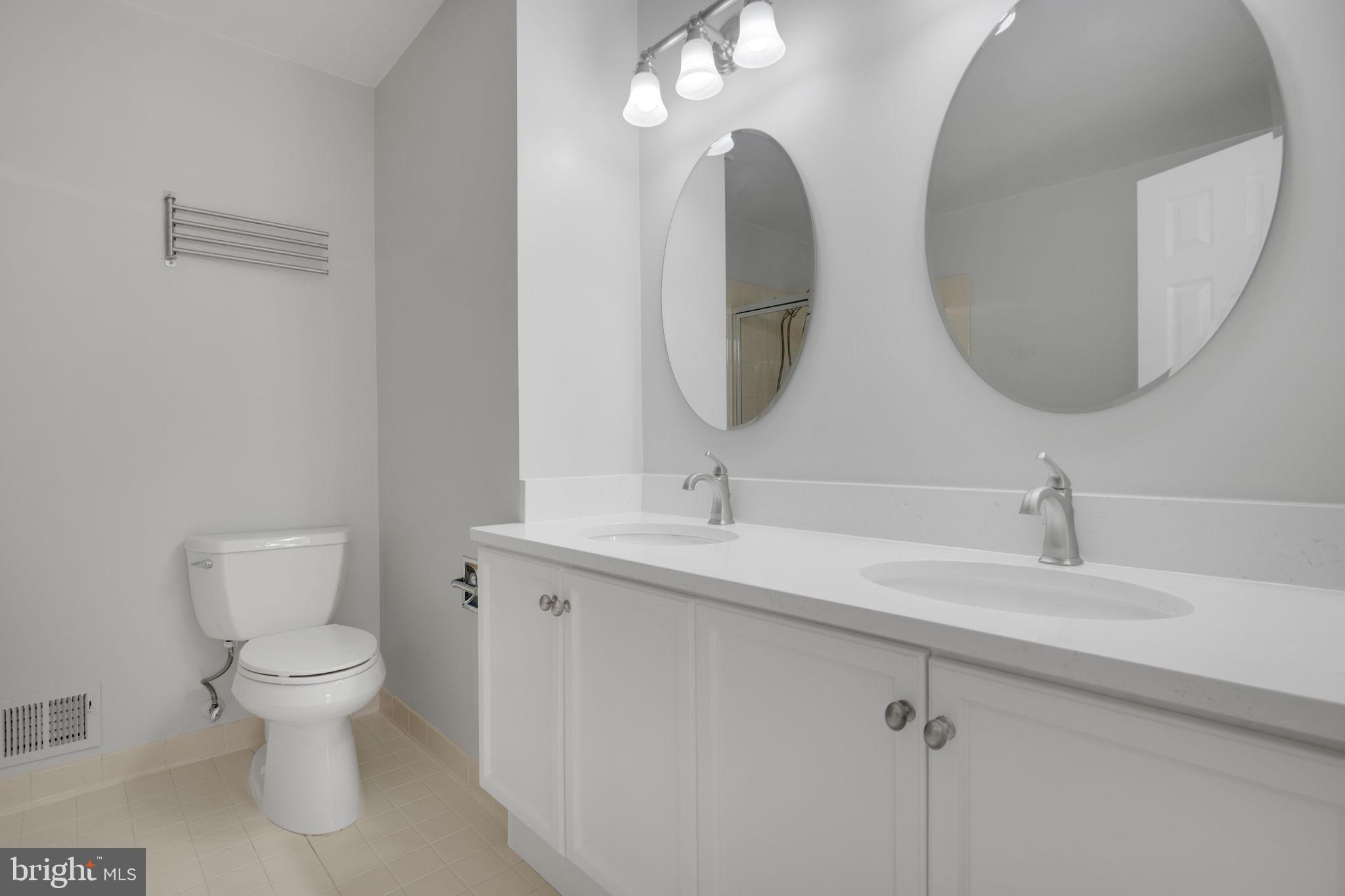 7267 Olde Lantern Way Springfield, VA 22152 - Photo 22 of 52 a bathroom with a toilet a sink and mirror