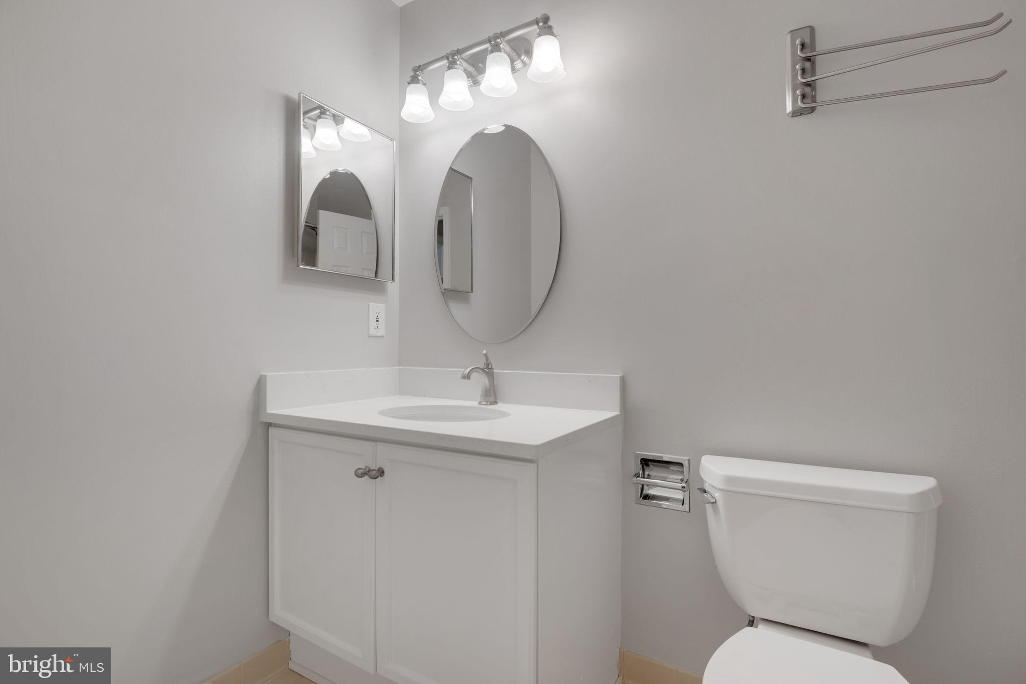 7267 Olde Lantern Way Springfield, VA 22152 - Photo 33 of 52 a bathroom with a toilet sink and mirror