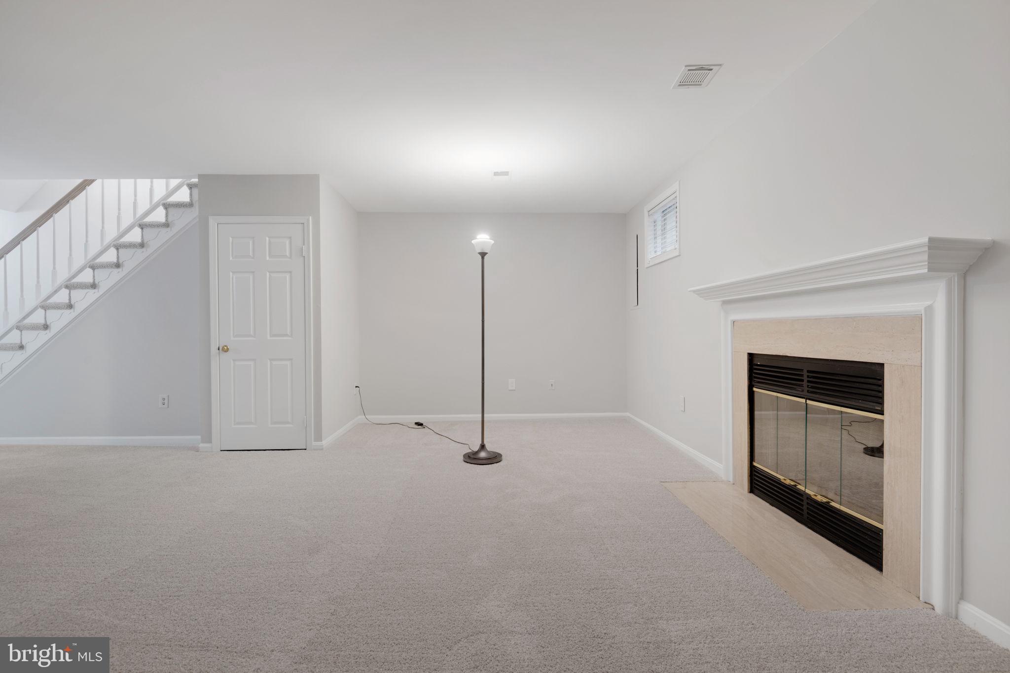 7267 Olde Lantern Way Springfield, VA 22152 - Photo 38 of 52 a view of an empty room with a fireplace