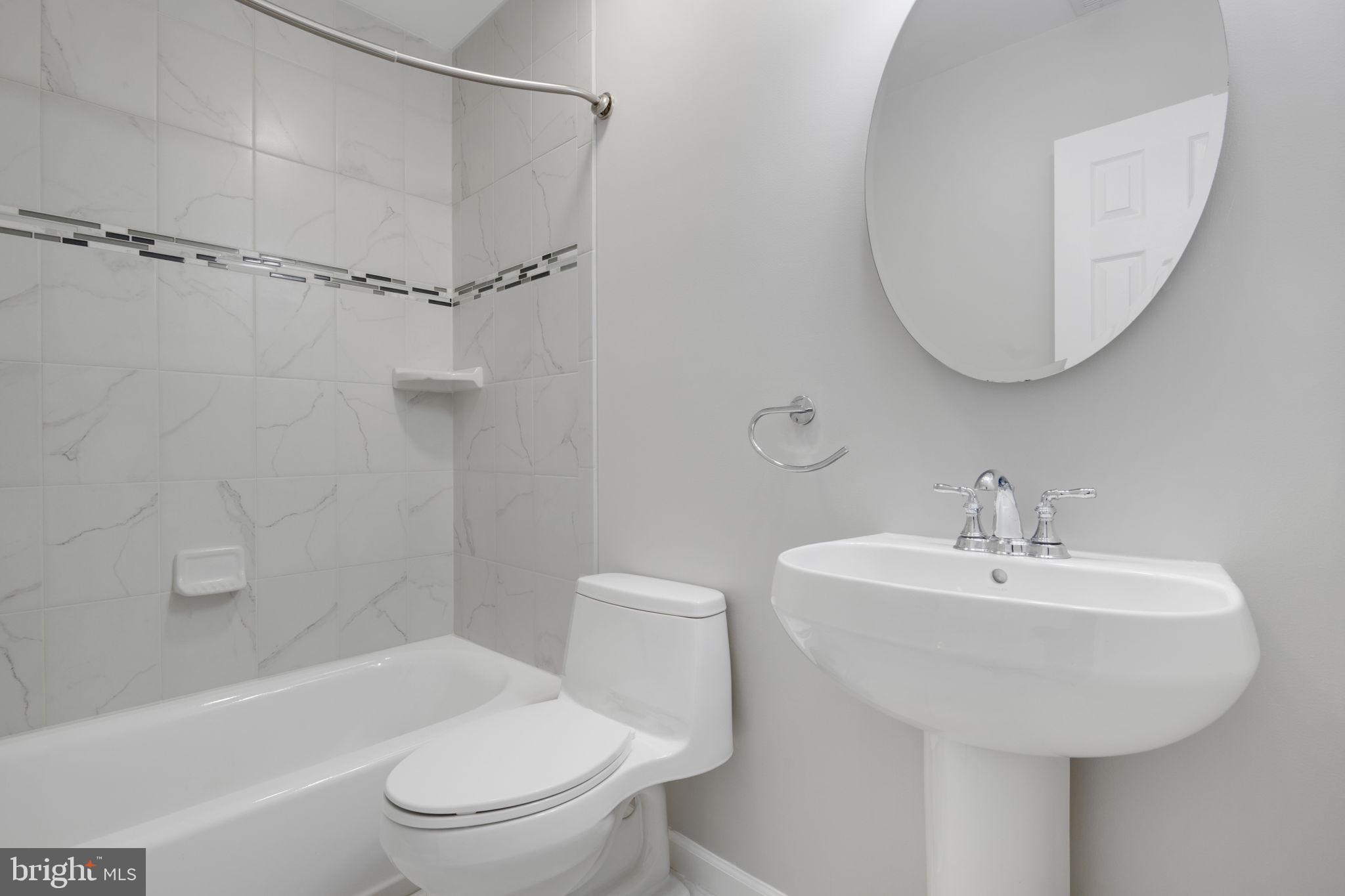 7267 Olde Lantern Way Springfield, VA 22152 - Photo 44 of 52 a bathroom with a sink a toilet and shower