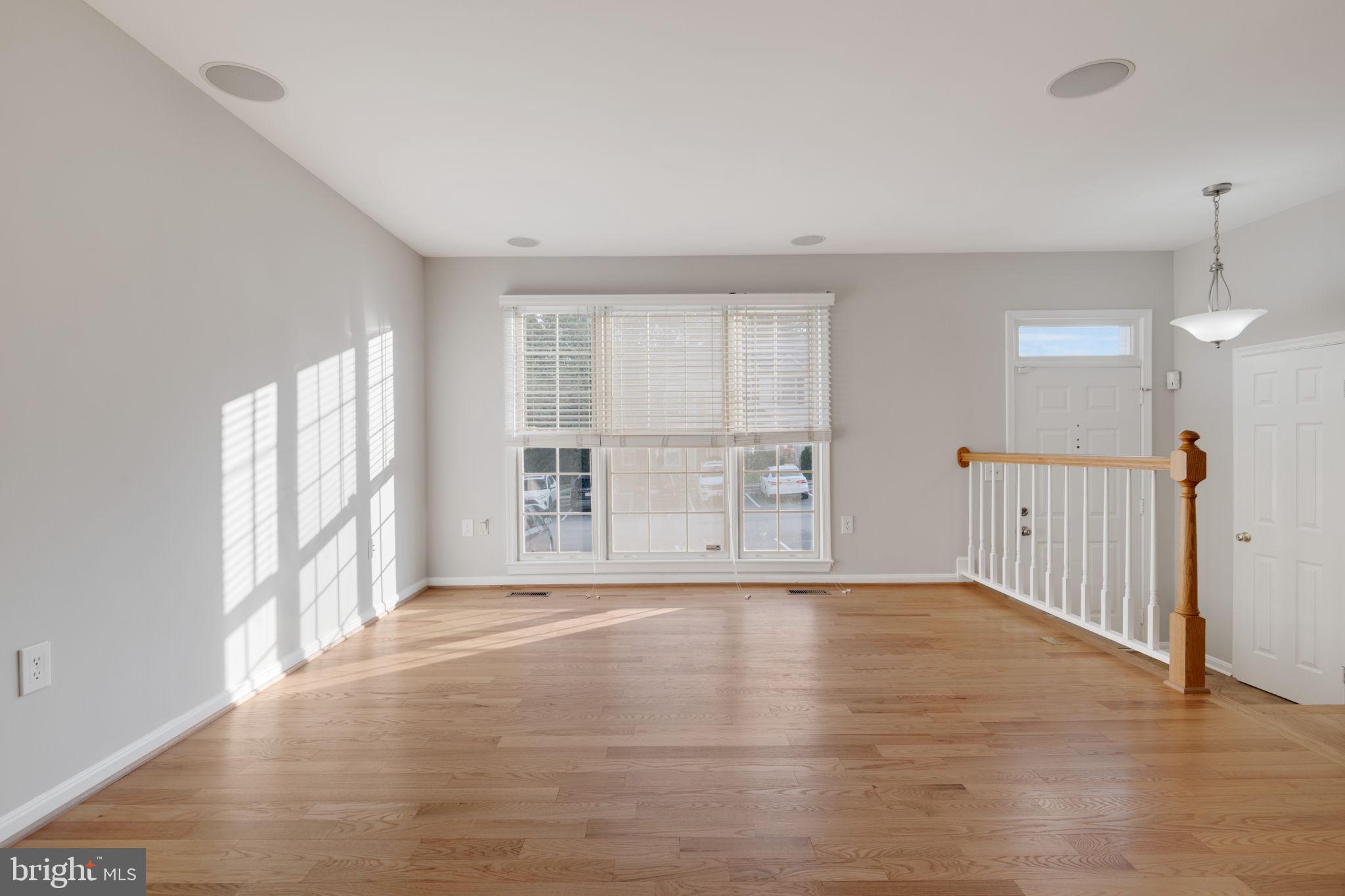 7267 Olde Lantern Way Springfield, VA 22152 - Photo 3 of 52 a view of an empty room with wooden floor and a window