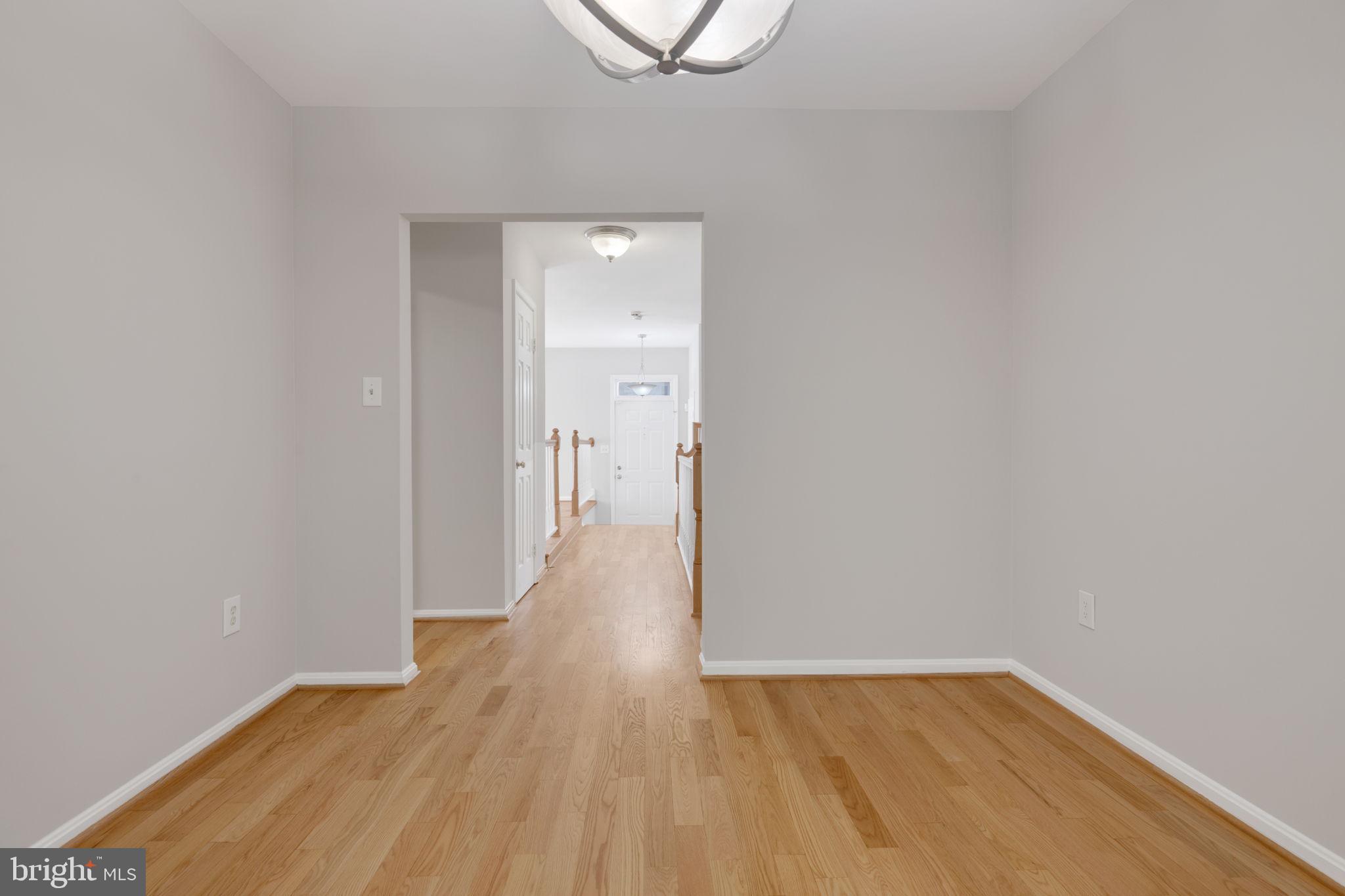 7267 Olde Lantern Way Springfield, VA 22152 - Photo 6 of 52 a view of a hallway with wooden floor