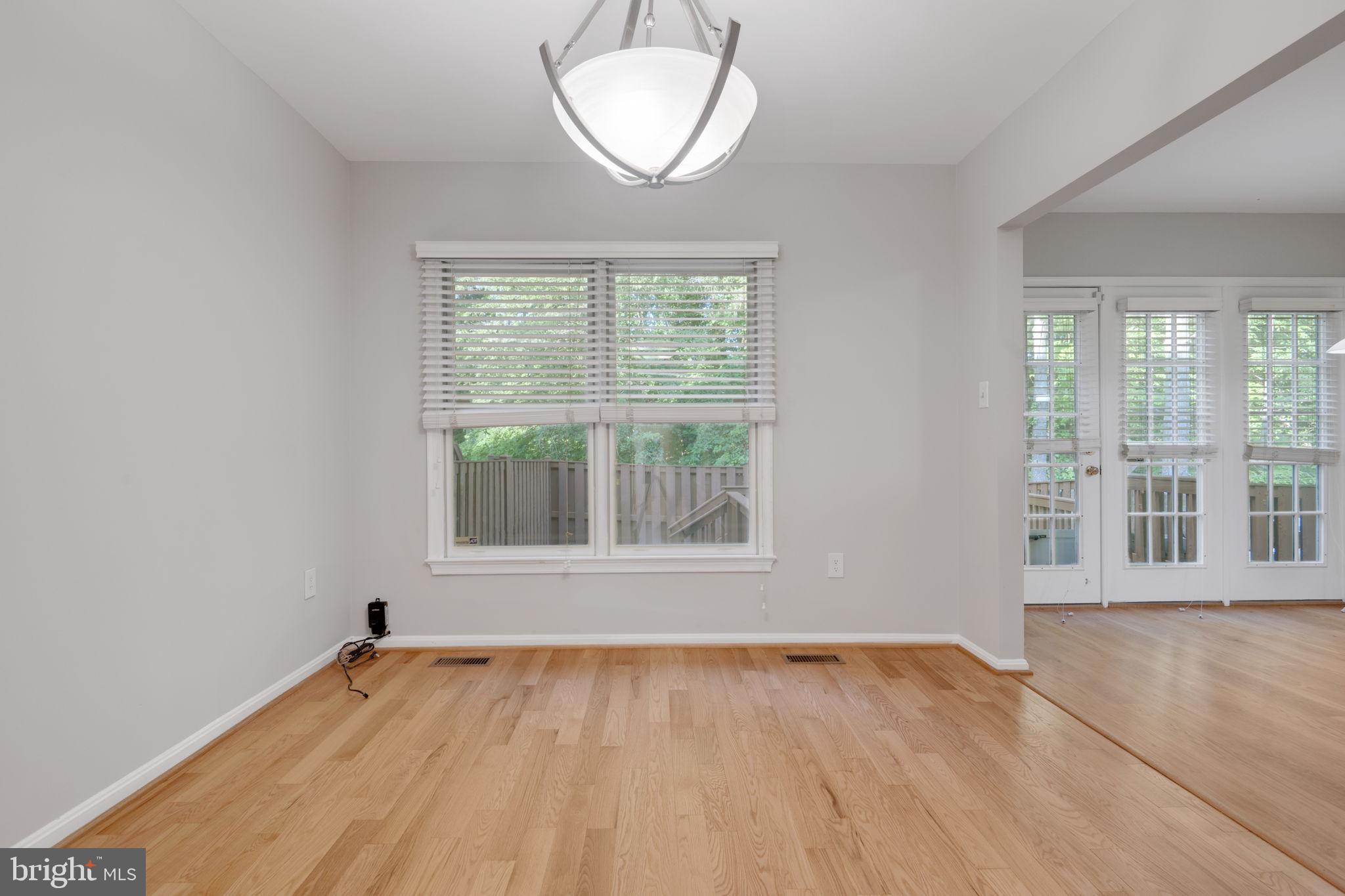 7267 Olde Lantern Way Springfield, VA 22152 - Photo 7 of 52 an empty room with wooden floor and windows