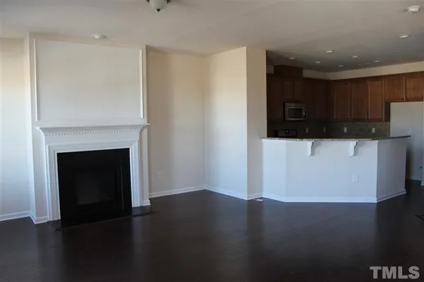 a view of a kitchen with a sink and a fireplace