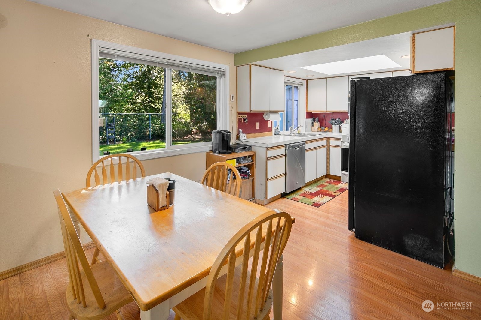 15612 119th Avenue Northeast Bothell, WA 98011 - Photo 18 of 32 a kitchen with a table chairs and refrigerator