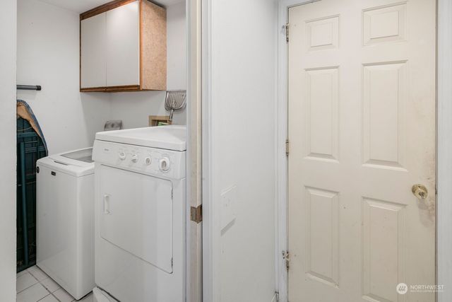 a view of bathroom with a sink washer and dryer