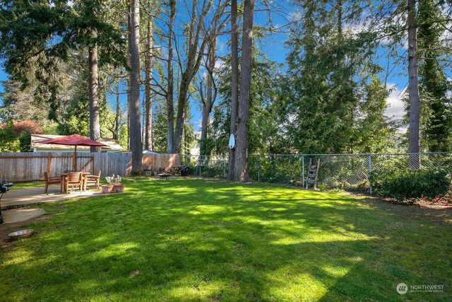 a backyard of a house with table and chairs