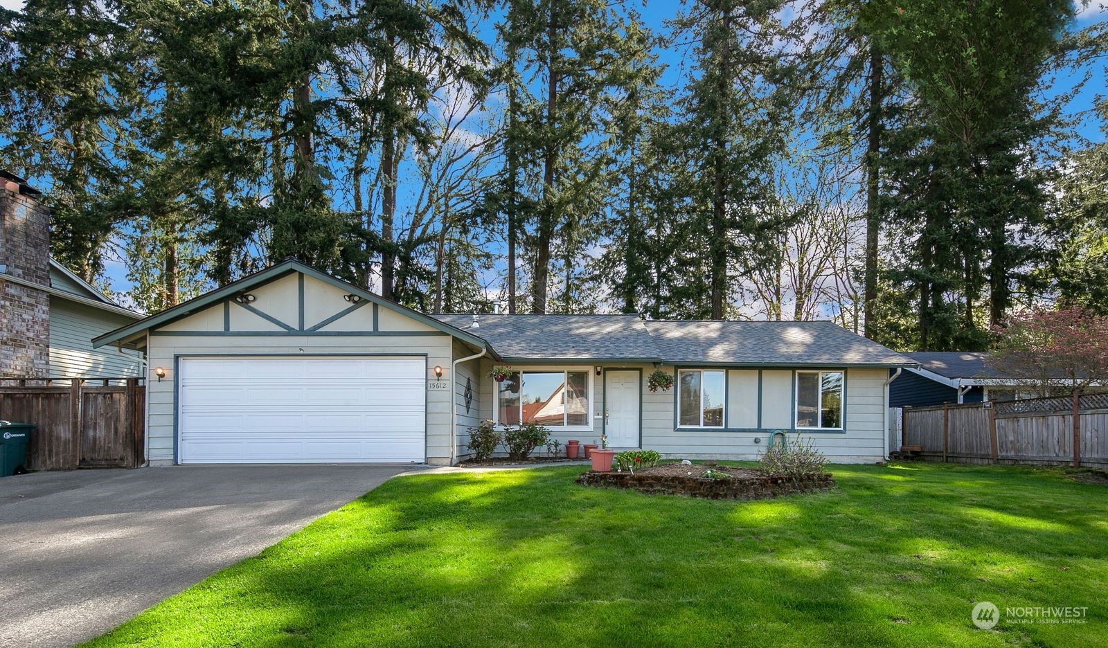 15612 119th Avenue Northeast Bothell, WA 98011 - Photo 3 of 32 a front view of a house with a garden and porch
