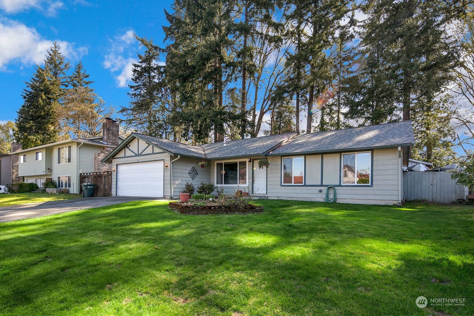 15612 119th Avenue Northeast Bothell, WA 98011 - Photo 4 of 32 a view of a house with a yard and trees