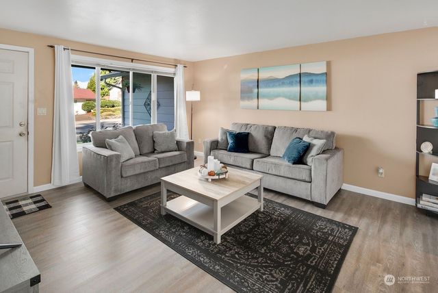 a living room with furniture and a rug