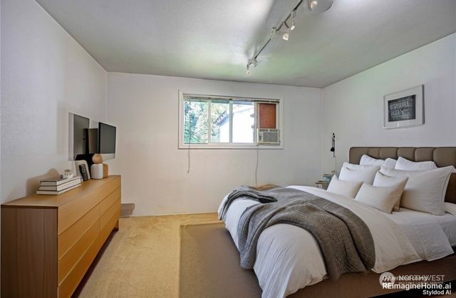 a bed room with a bed and a television