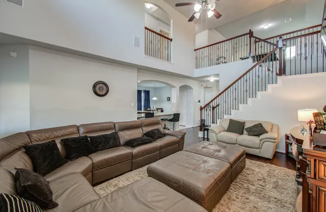 a living room with furniture and a clock