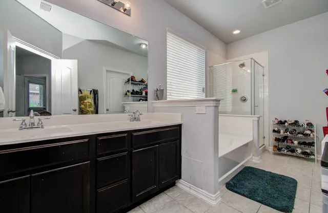 a bathroom with a sink double vanity and a mirror