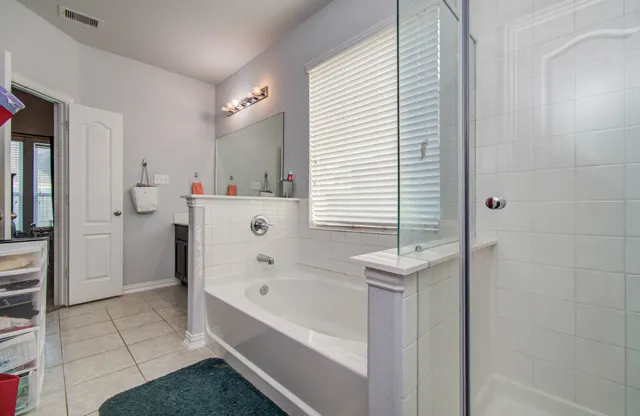 a bathroom with a bathtub and a shower