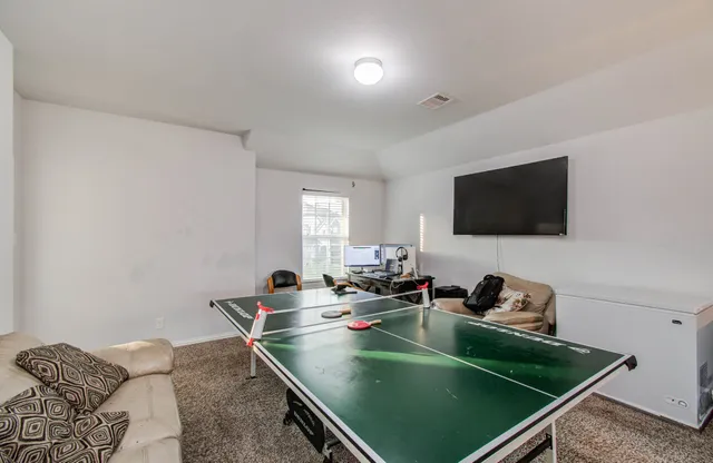 a room with furniture and flat screen tv