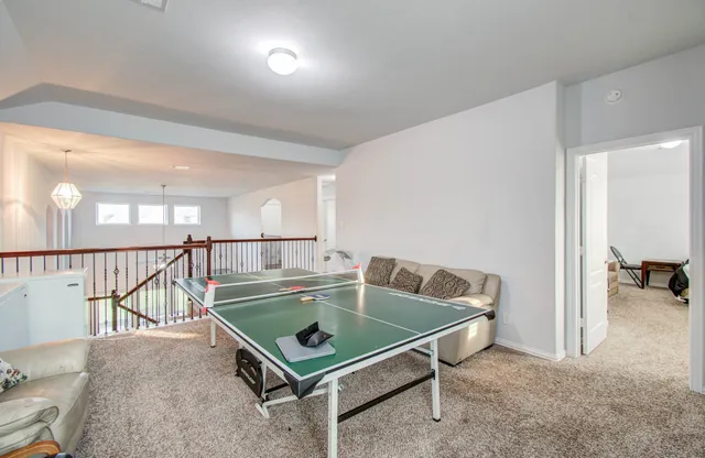 a room with pool table and windows
