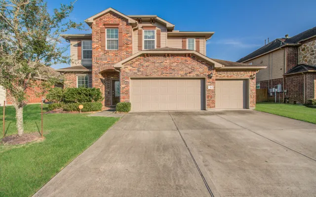 a front view of a house with a garden and plants
