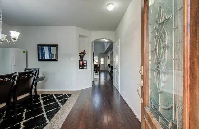 a view of a hallway with wooden floor and glass door