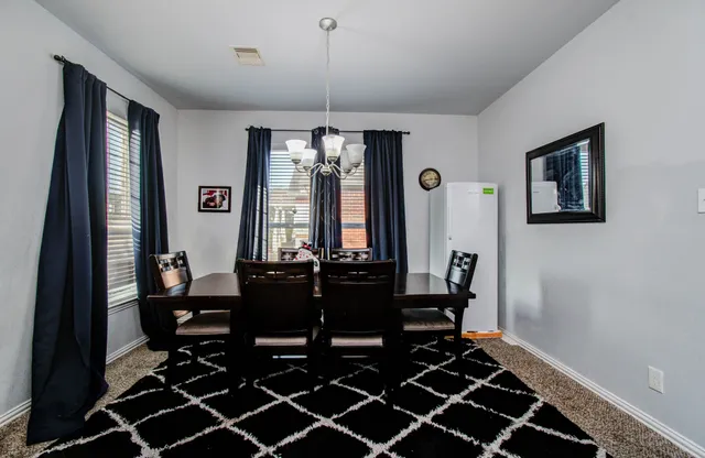 a dining room with furniture and window