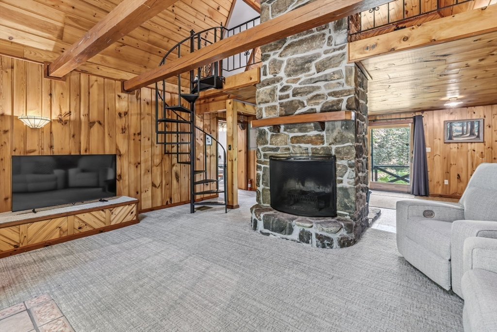 345 Harvey Road Worthington, MA 01098 - Photo 9 of 41 a living room with furniture a flat screen tv and a fireplace
