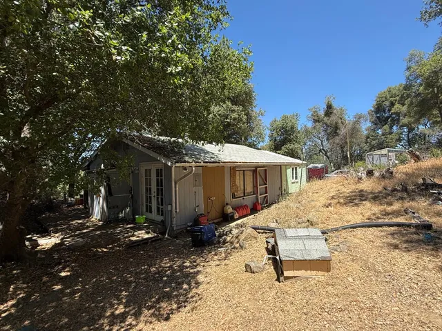 a view of a small house with a patio