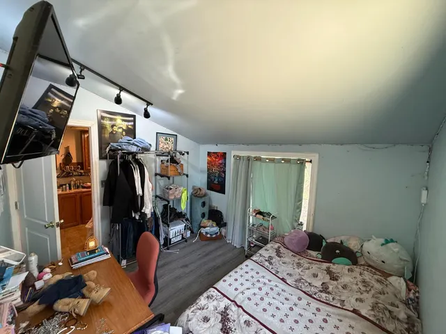 a bedroom with furniture and a window