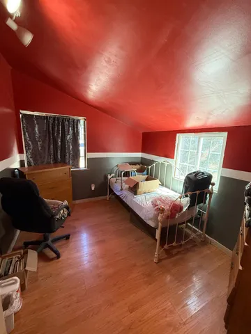 a bedroom with furniture and a window