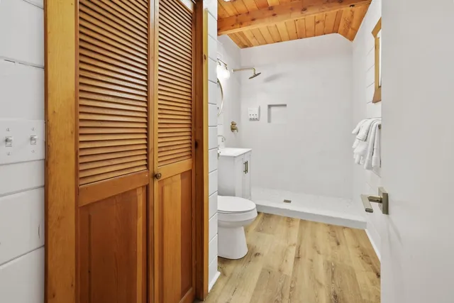 a bathroom with a toilet and a shower