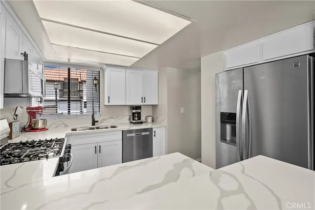 a kitchen with a sink a stove and refrigerator