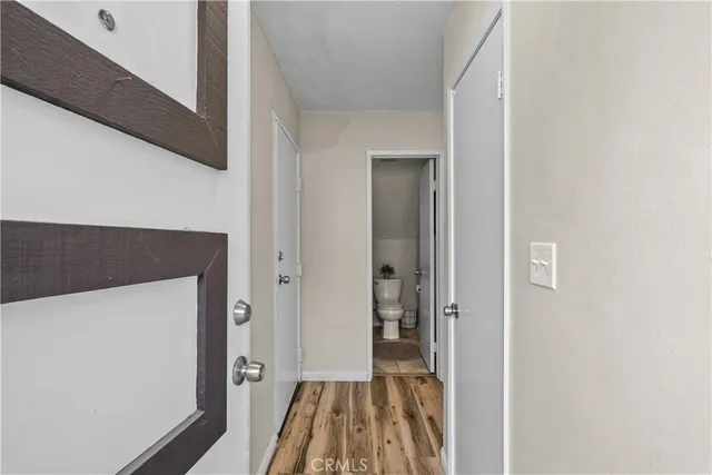 a view of a hallway with wooden floor and staircase