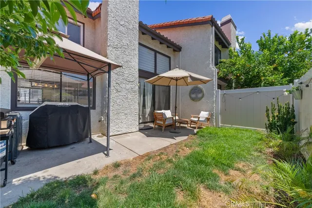 a view of a chair and table under an umbrella