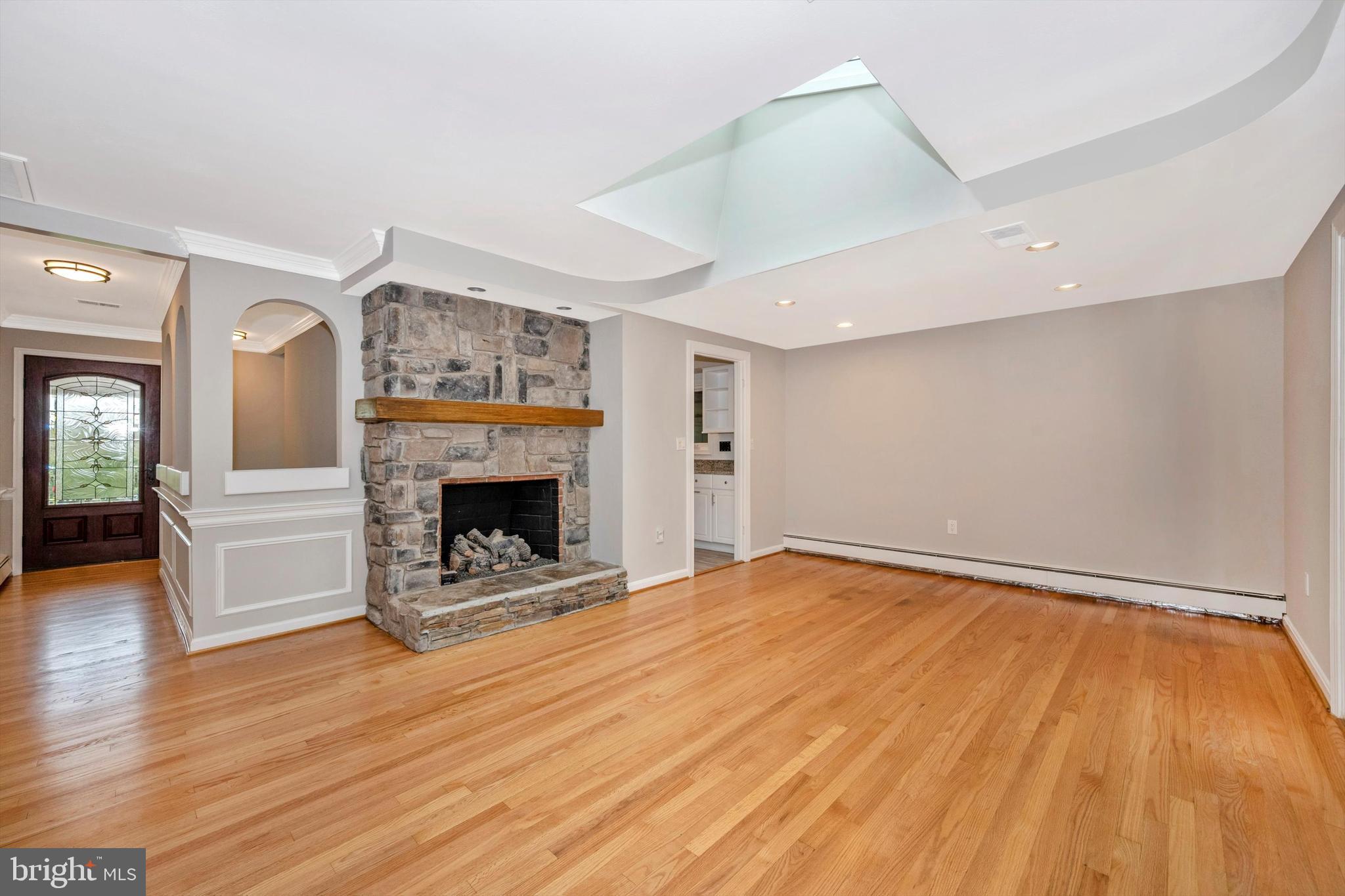 9421 Emory Grove Road Gaithersburg, MD 20877 - Photo 9 of 38 Living room with skylight and gas fireplace