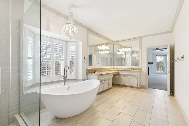 a bathroom with a tub sink shower and view