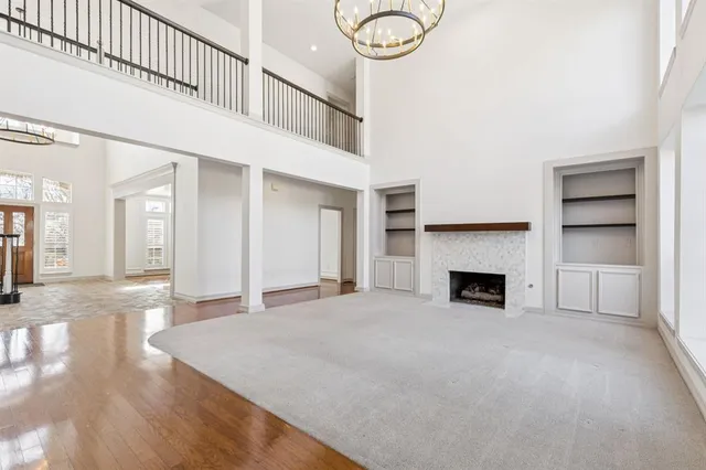 a view of an empty room with a fireplace and a window