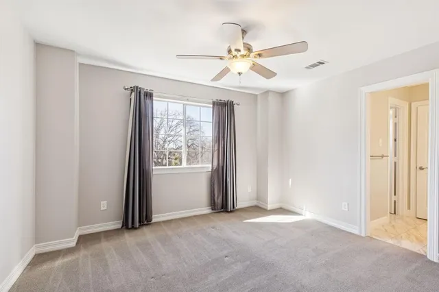 a bathroom with a sink a toilet and a large mirror