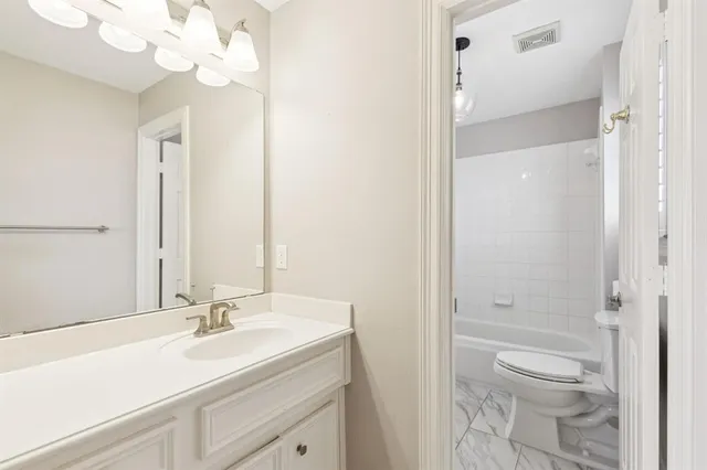a bathroom with a sink vanity and a mirror