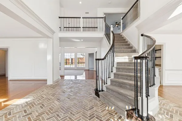 a view of staircase with white walls and windows